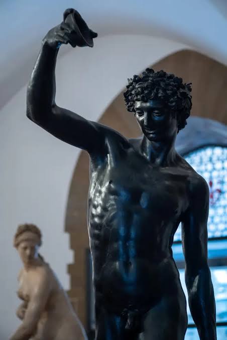 Tourist filmed kissing the statue of Bacchus, the god of wine and sensuality in Italy